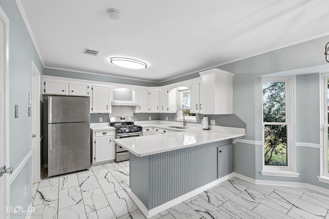 kitchen with white cabinetry, sink, kitchen peninsula, stainless steel appliances, and crown molding