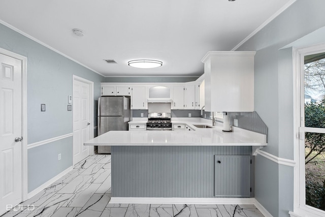 kitchen featuring sink, appliances with stainless steel finishes, white cabinetry, ornamental molding, and kitchen peninsula