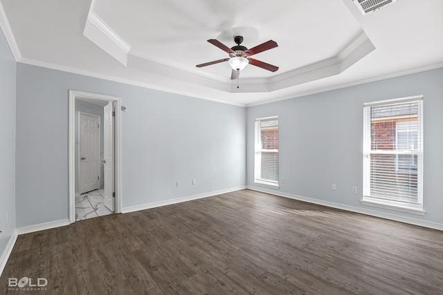 spare room featuring hardwood / wood-style floors, crown molding, a raised ceiling, and ceiling fan