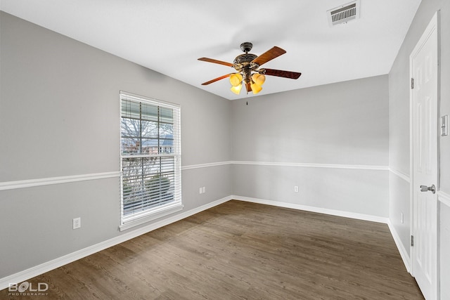 spare room featuring dark wood-type flooring and ceiling fan