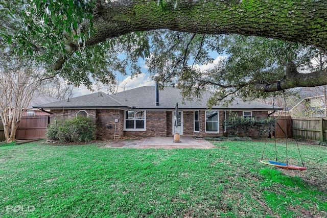 rear view of property with a patio and a lawn