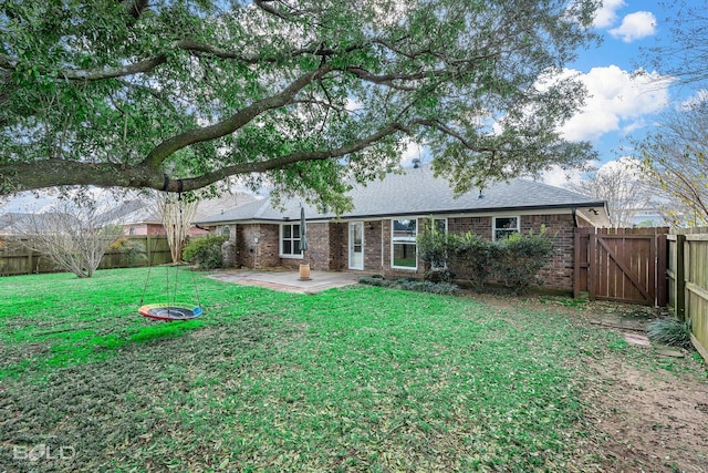 rear view of property featuring a patio area and a lawn