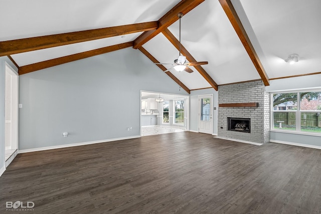 unfurnished living room with ceiling fan, beam ceiling, high vaulted ceiling, dark hardwood / wood-style floors, and a fireplace