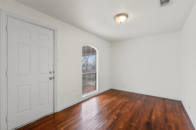 unfurnished room with dark hardwood / wood-style flooring