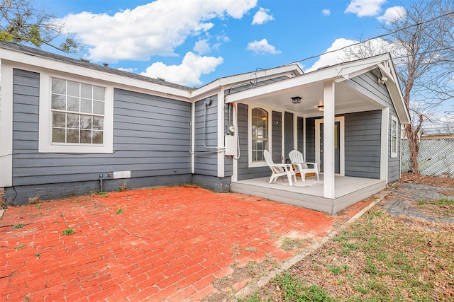 back of house with a porch and a patio