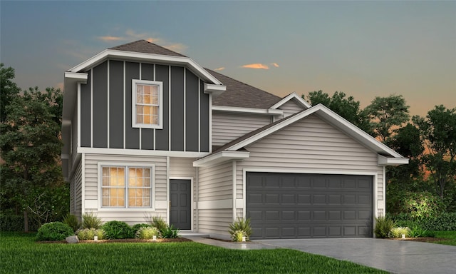 view of front facade with a garage and a lawn