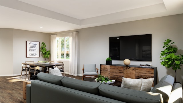 living room featuring a raised ceiling, dark wood finished floors, and baseboards