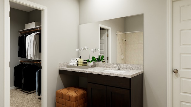 full bath featuring a shower, a walk in closet, and vanity