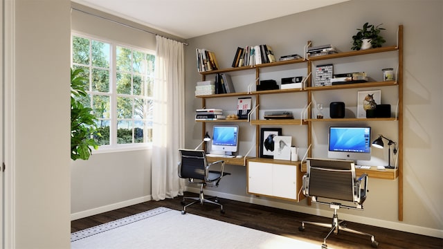 office with baseboards, dark wood-style flooring, and a healthy amount of sunlight