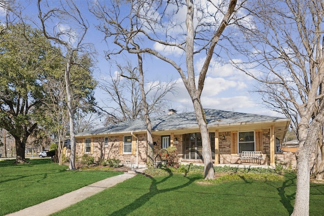 ranch-style home with a porch and a front yard