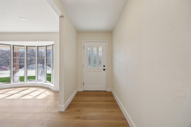 doorway to outside with light wood-type flooring