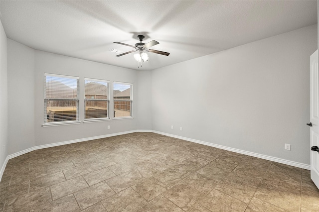 unfurnished room with ceiling fan and a textured ceiling