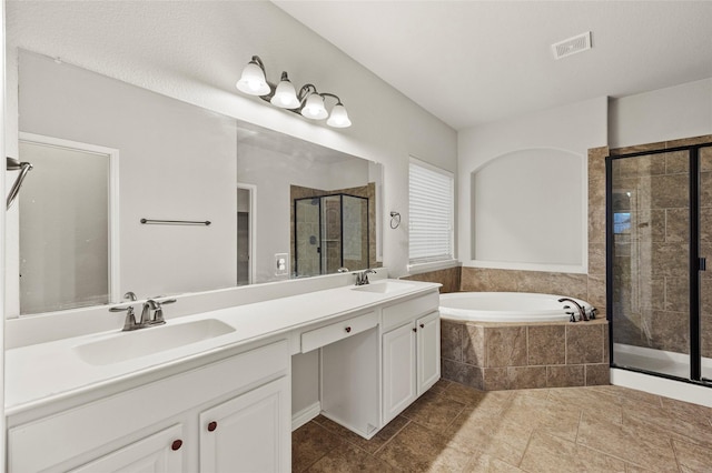 bathroom with vanity and independent shower and bath