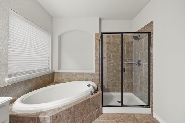 bathroom with plus walk in shower and tile patterned flooring