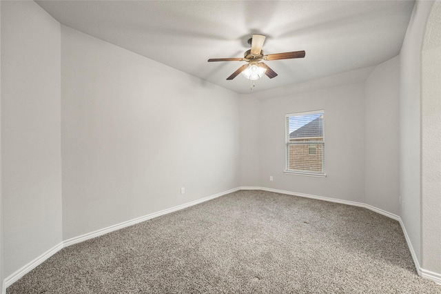 empty room featuring ceiling fan and carpet flooring