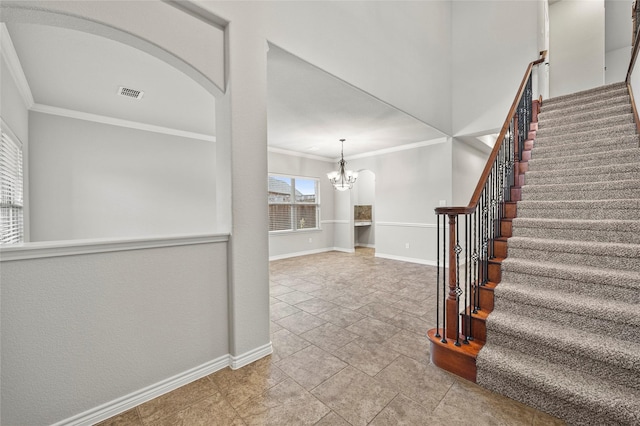 interior space featuring ornamental molding and a chandelier