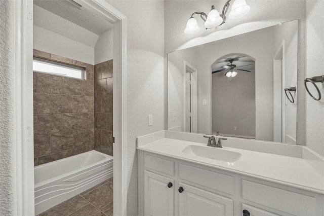 bathroom featuring vanity, ceiling fan, tile patterned floors, and tiled shower / bath