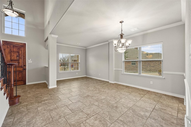 entryway featuring crown molding and an inviting chandelier