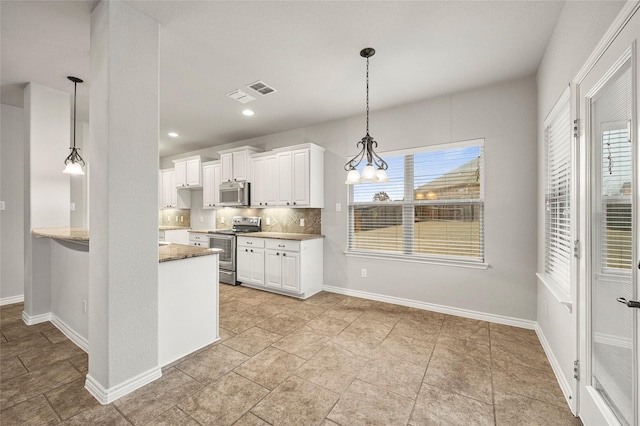 kitchen featuring decorative light fixtures, white cabinets, decorative backsplash, light stone counters, and stainless steel appliances