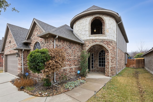 view of front facade featuring a garage and a front lawn