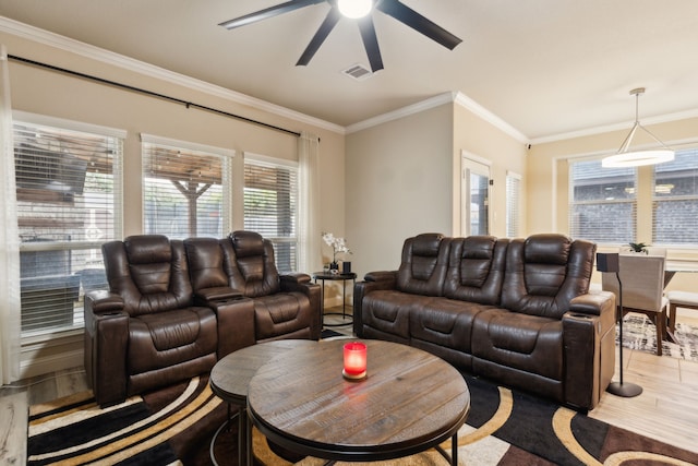 living room with ornamental molding, light hardwood / wood-style floors, and ceiling fan