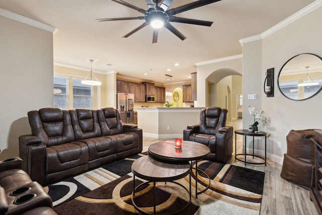 living room featuring ornamental molding, ceiling fan, and light hardwood / wood-style floors