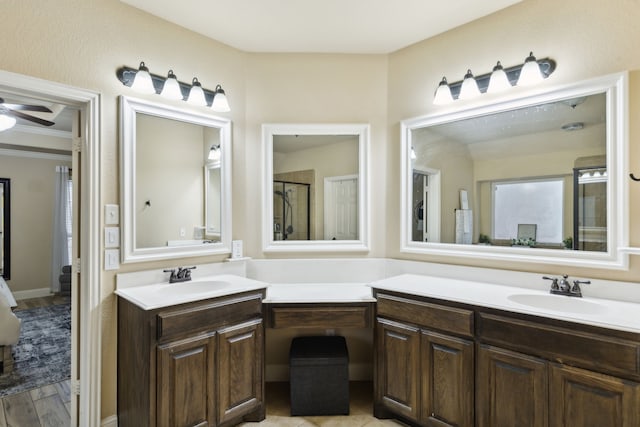 bathroom with ceiling fan, vanity, a shower with shower door, and wood-type flooring