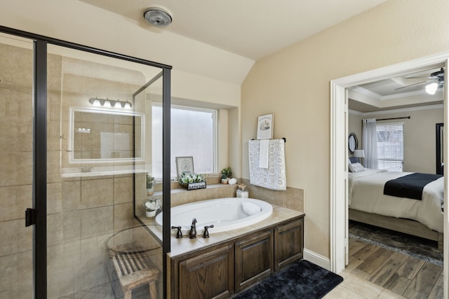 bathroom featuring ceiling fan, ornamental molding, separate shower and tub, and wood-type flooring