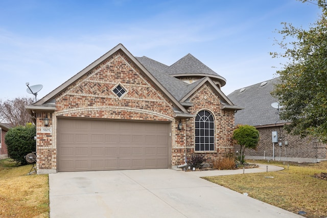 view of front facade with a garage and a front lawn