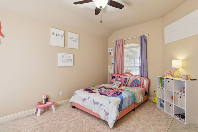 bedroom with ceiling fan, lofted ceiling, and carpet flooring