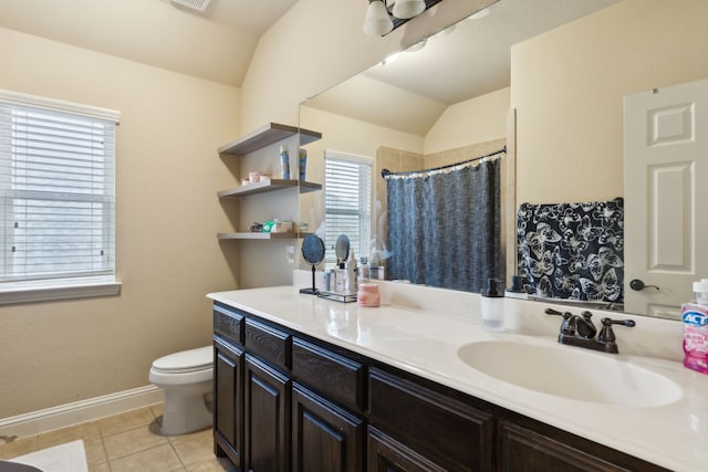 bathroom featuring tile patterned flooring, vanity, curtained shower, vaulted ceiling, and toilet