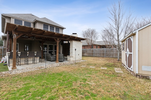 rear view of house with a yard, an outdoor hangout area, a shed, and a patio area