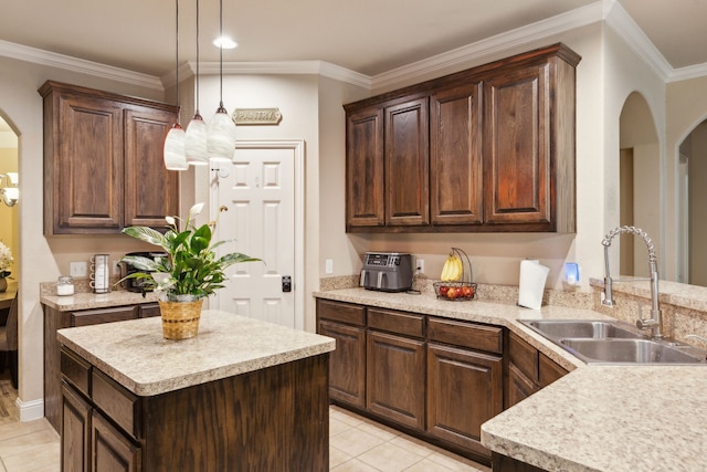 kitchen with dark brown cabinets, sink, and hanging light fixtures