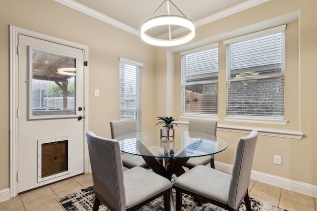 dining room featuring crown molding and light tile patterned floors