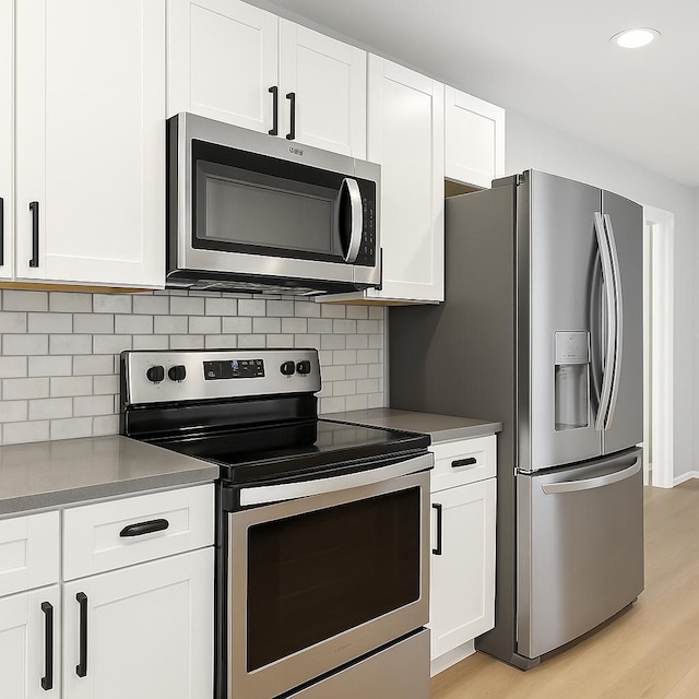 3404 Peachtree Ln, Pantego, TX 76013 - kitchen featuring stainless steel appliances, light wood-type flooring, white cabinets, decorative backsplash, and recessed lighting