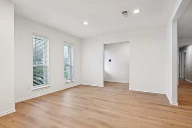 spare room with light hardwood / wood-style flooring