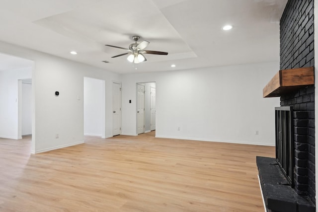 3404 Peachtree Ln, Pantego, TX 76013 - unfurnished living room featuring a brick fireplace, ceiling fan, recessed lighting, light wood-type flooring, and baseboards