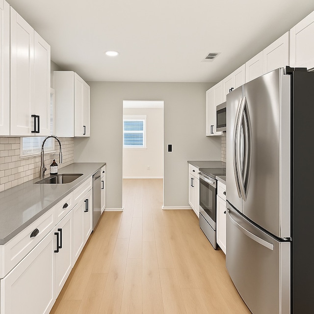 3404 Peachtree Ln, Pantego, TX 76013 - kitchen with stainless steel appliances, a sink, backsplash, recessed lighting, and white cabinetry
