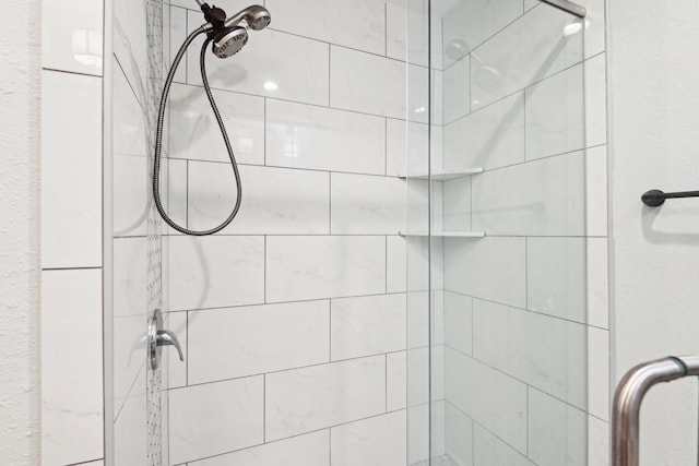 bathroom featuring a shower with door