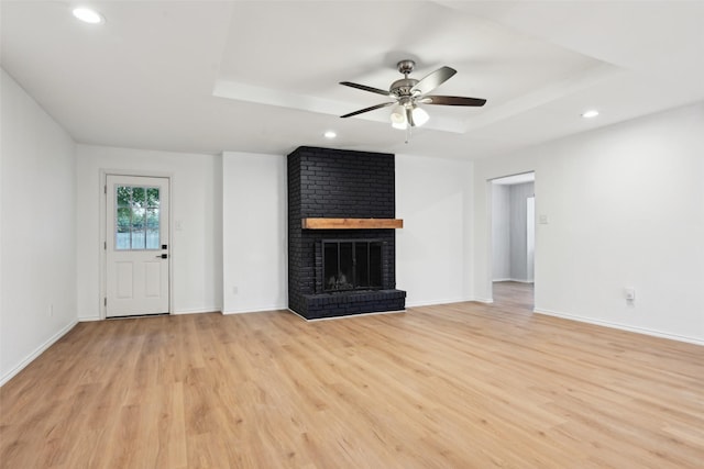 3404 Peachtree Ln, Pantego, TX 76013 - unfurnished living room with a raised ceiling, a ceiling fan, light wood-style floors, recessed lighting, and a fireplace
