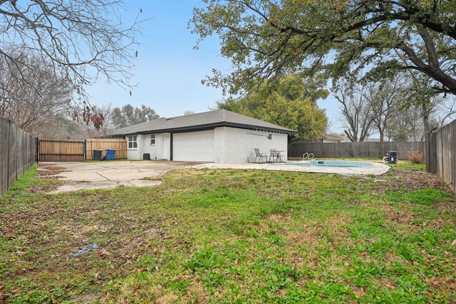 3404 Peachtree Ln, Pantego, TX 76013 - rear view of property featuring brick siding, a patio, and an attached garage