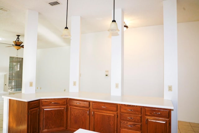 kitchen featuring light tile patterned floors, kitchen peninsula, ceiling fan, and decorative light fixtures