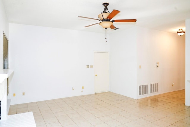 unfurnished living room featuring ceiling fan and light tile patterned floors