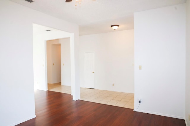 empty room featuring ceiling fan and light hardwood / wood-style floors