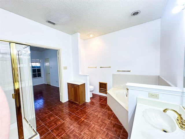 full bathroom featuring separate shower and tub, parquet floors, a textured ceiling, and toilet