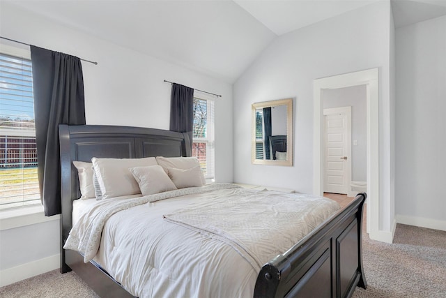 carpeted bedroom with lofted ceiling