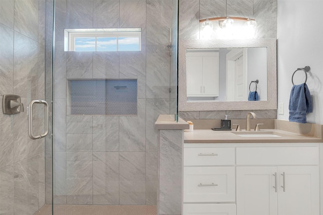 bathroom featuring an enclosed shower and vanity