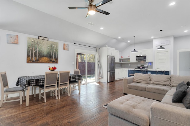 living room with vaulted ceiling, dark hardwood / wood-style floors, and ceiling fan