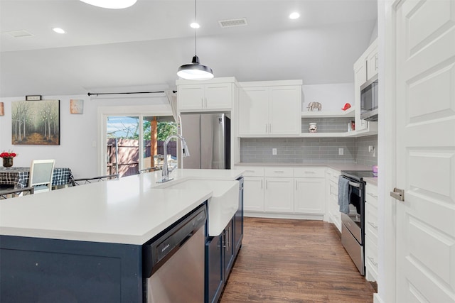 kitchen featuring a kitchen island with sink, hanging light fixtures, white cabinets, and appliances with stainless steel finishes