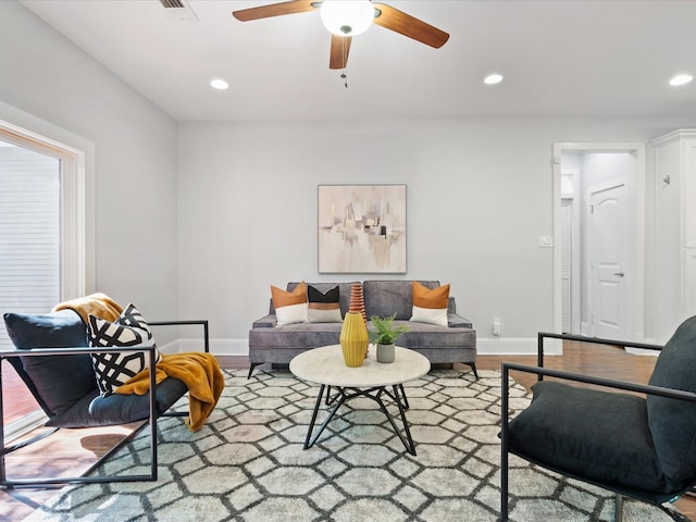 living room featuring hardwood / wood-style flooring and ceiling fan